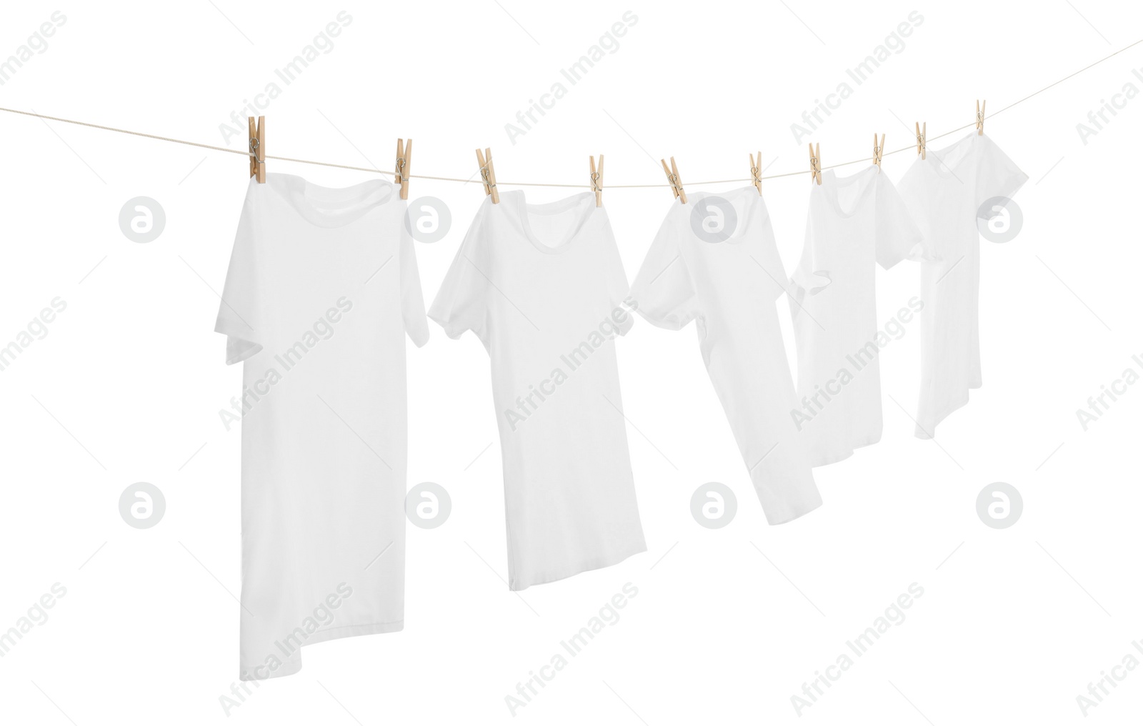 Photo of Many t-shirts drying on washing line isolated on white