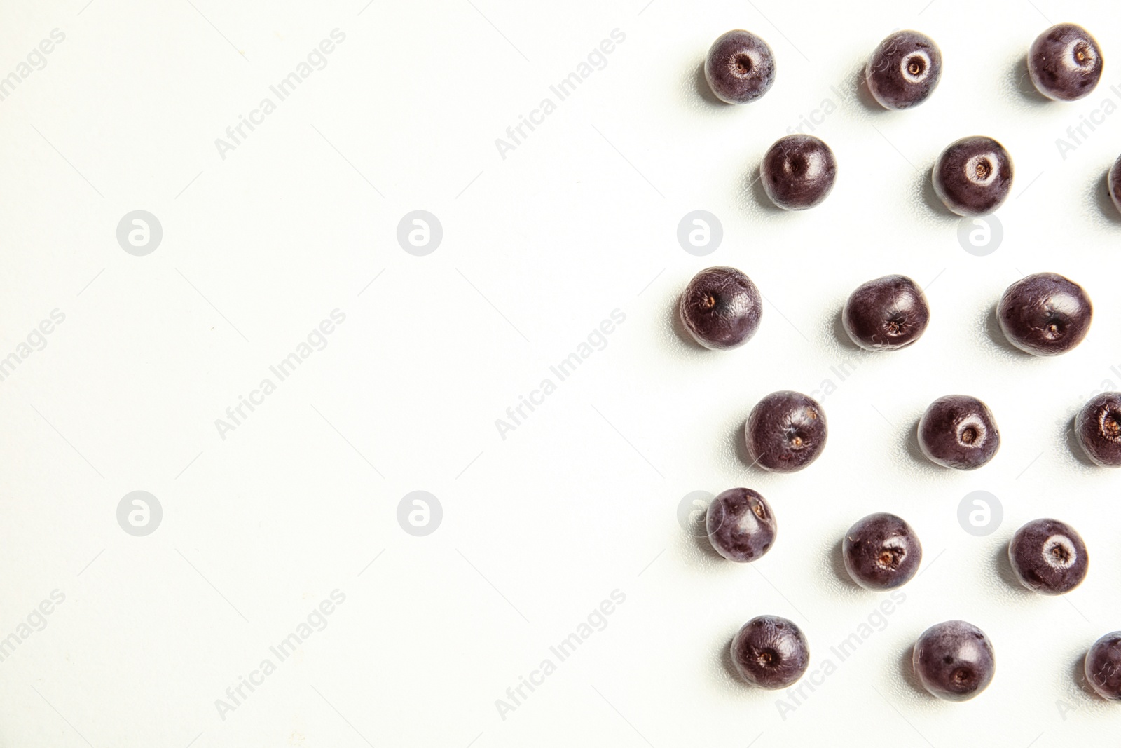 Photo of Fresh acai berries on white background