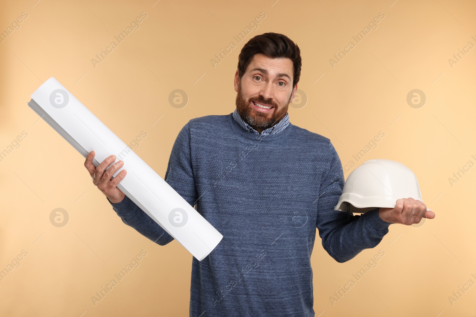 Photo of Confused architect with hard hat and draft on beige background