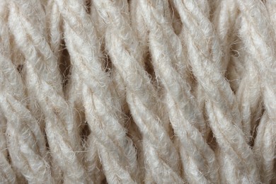 Macro photo of white woolen yarn as background, top view