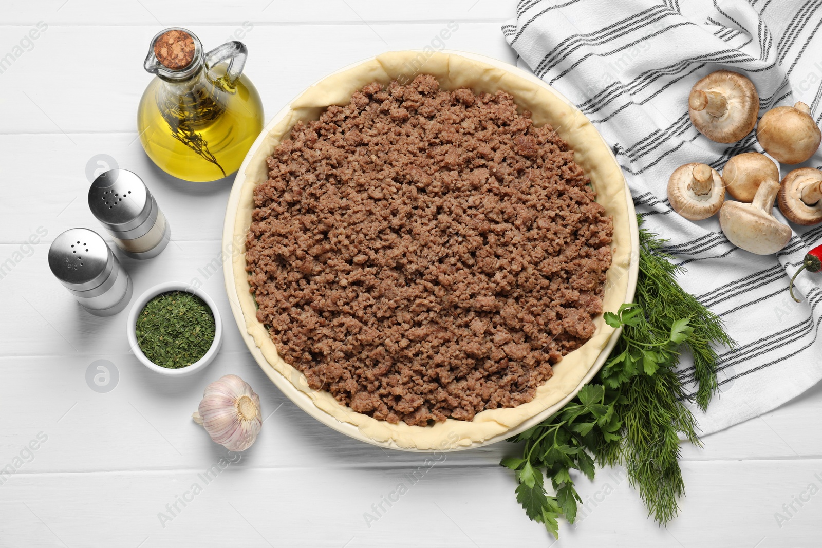 Photo of Flat lay composition with raw dough and ingredients on white wooden table. Baking meat pie