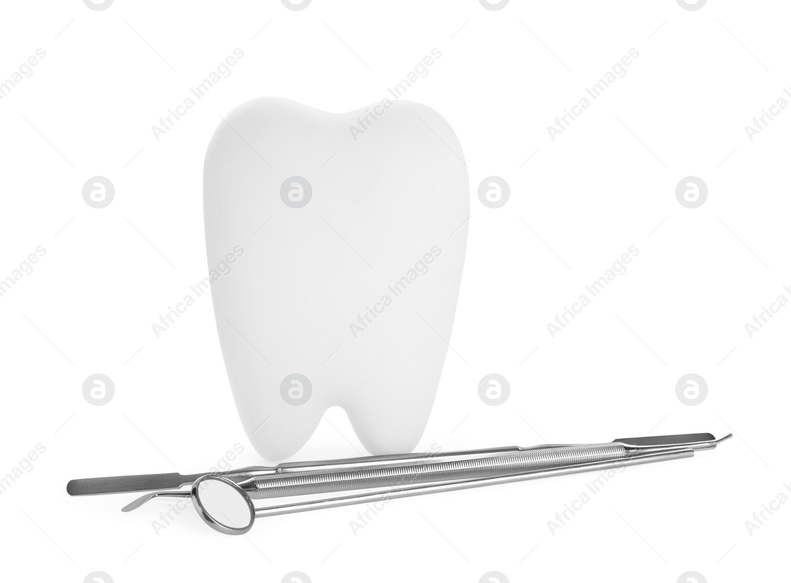 Photo of Tooth shaped holder and dental tools on white background