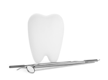 Photo of Tooth shaped holder and dental tools on white background