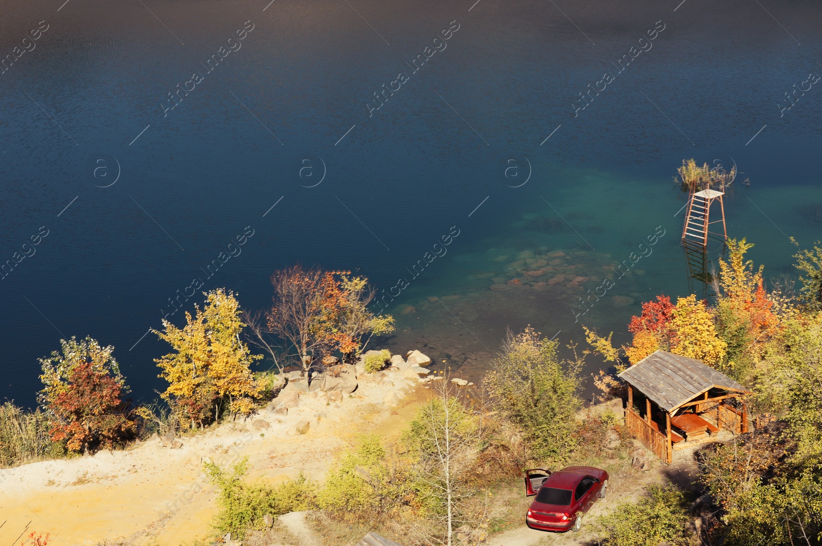 Photo of Parked car near gazebo on picturesque coast