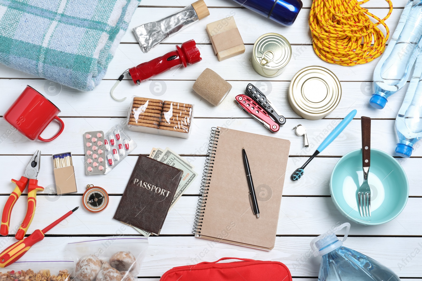 Photo of Disaster supply kit for earthquake on white wooden table, flat lay