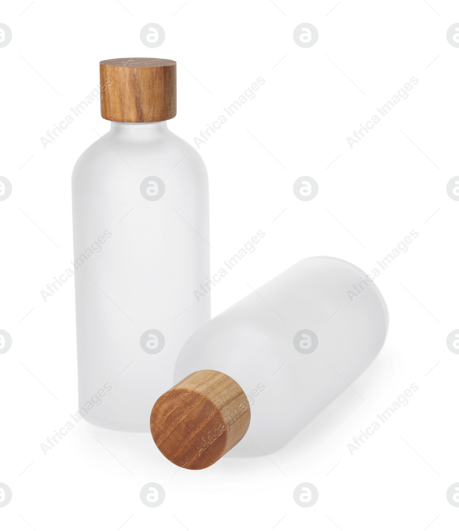 Photo of New empty glass bottles with wooden caps isolated on white