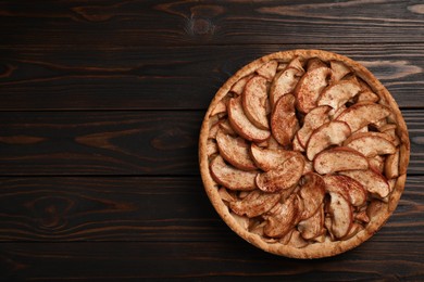 Photo of Delicious apple pie on wooden table, top view. Space for text