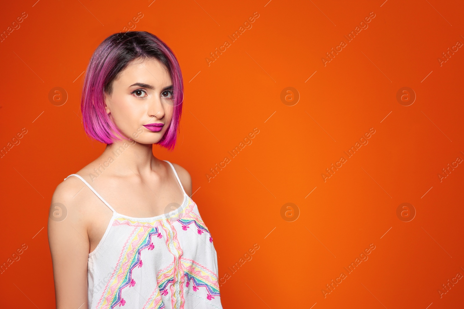 Photo of Young woman with trendy hairstyle against color background