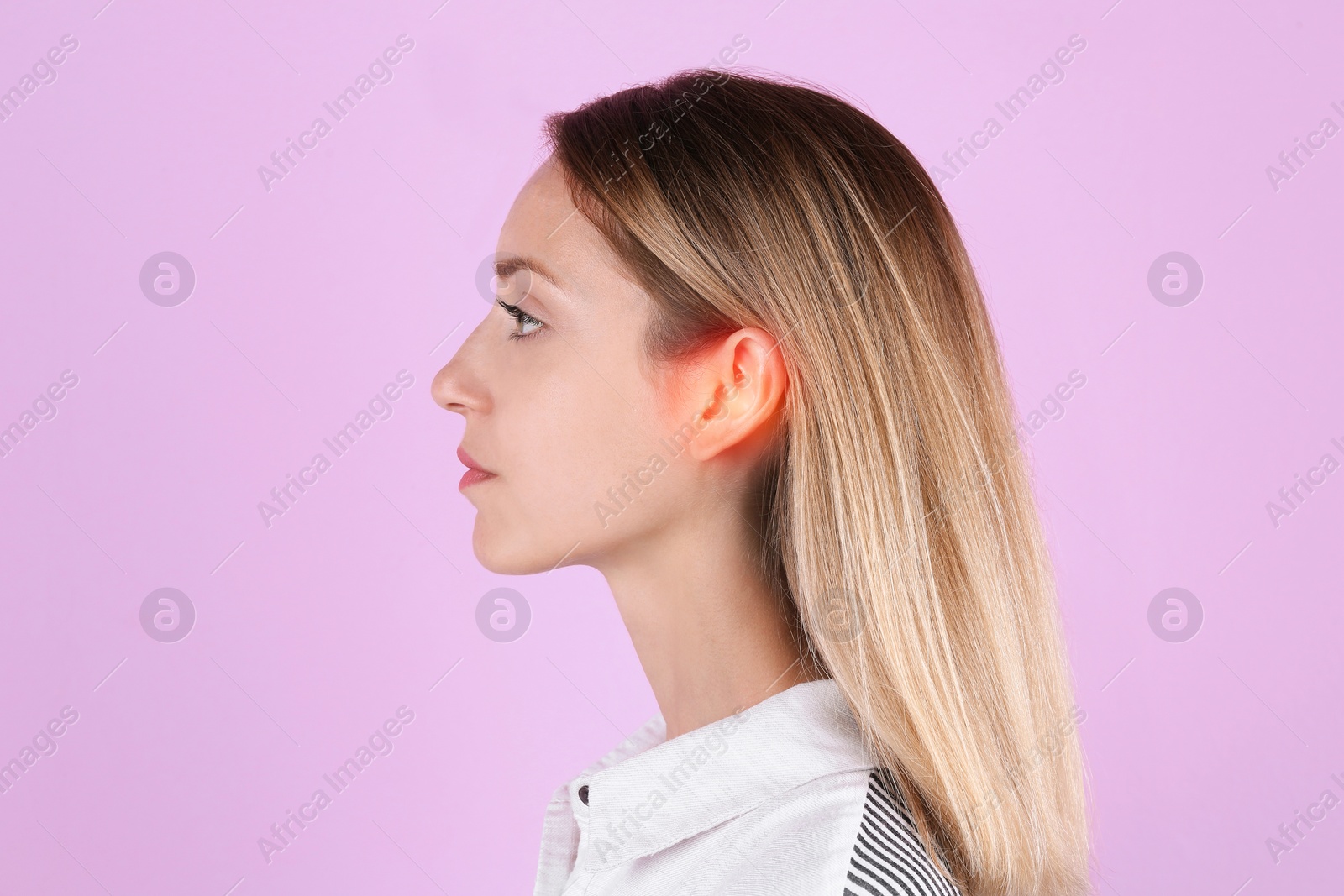 Image of Young woman with hearing problem on pink background