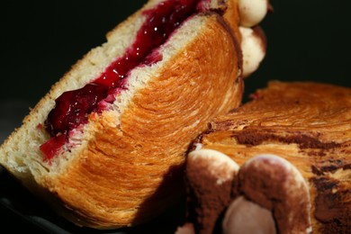 Photo of Round croissant with jam on plate, closeup. Tasty puff pastry