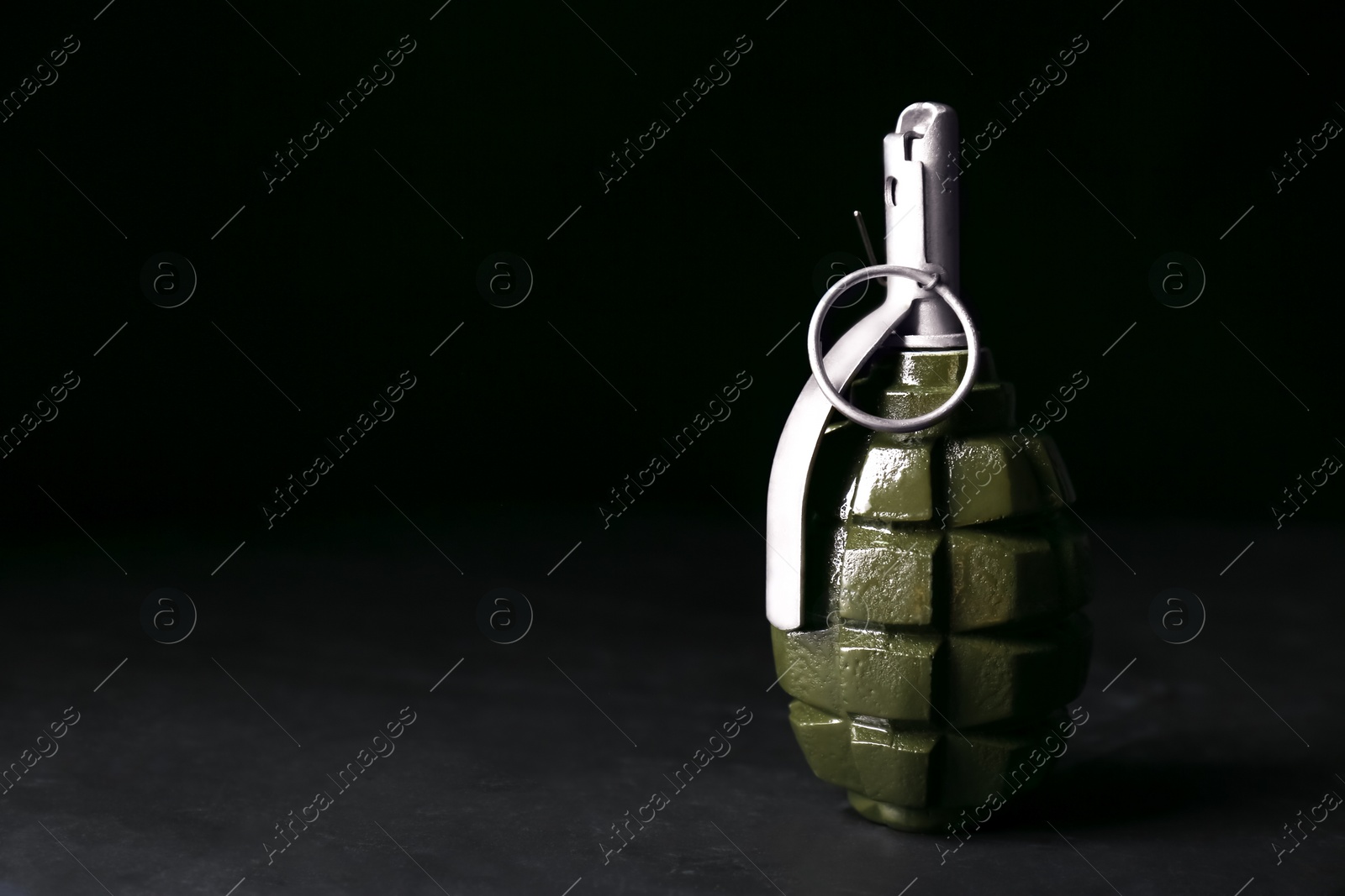 Photo of Hand grenade on black background. Space for text