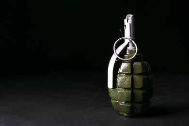 Photo of Hand grenade on black background. Space for text