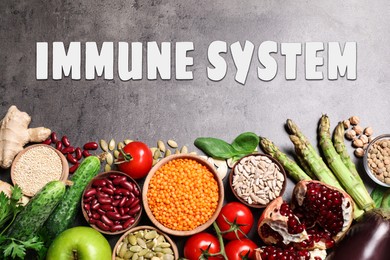 Image of Immune system boosting with proper nutrition. Different foods on grey table, flat lay