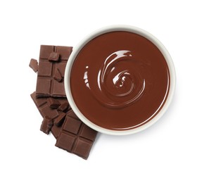 Photo of Milk chocolate paste in bowl and pieces isolated on white, top view