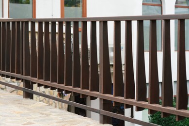 Wooden brown fence near modern building outdoors