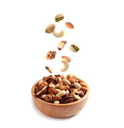 Different nuts falling into bowl on white background 
