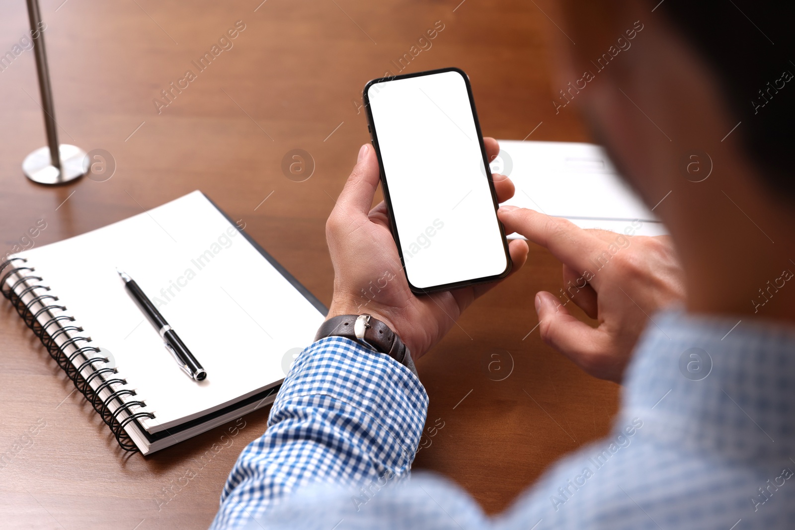 Photo of Man using smartphone at table, closeup view