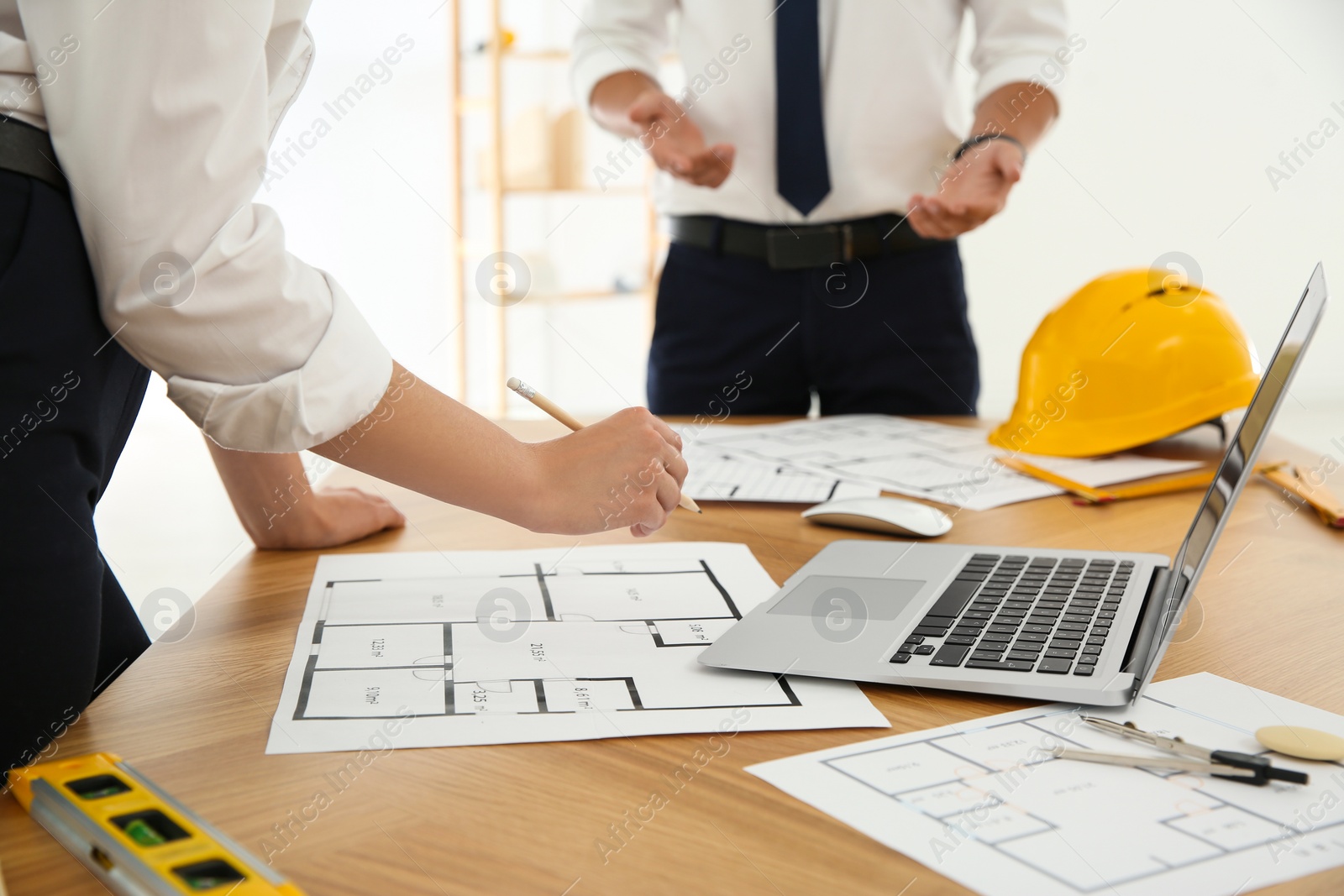 Photo of People working with construction drawings at table, closeup