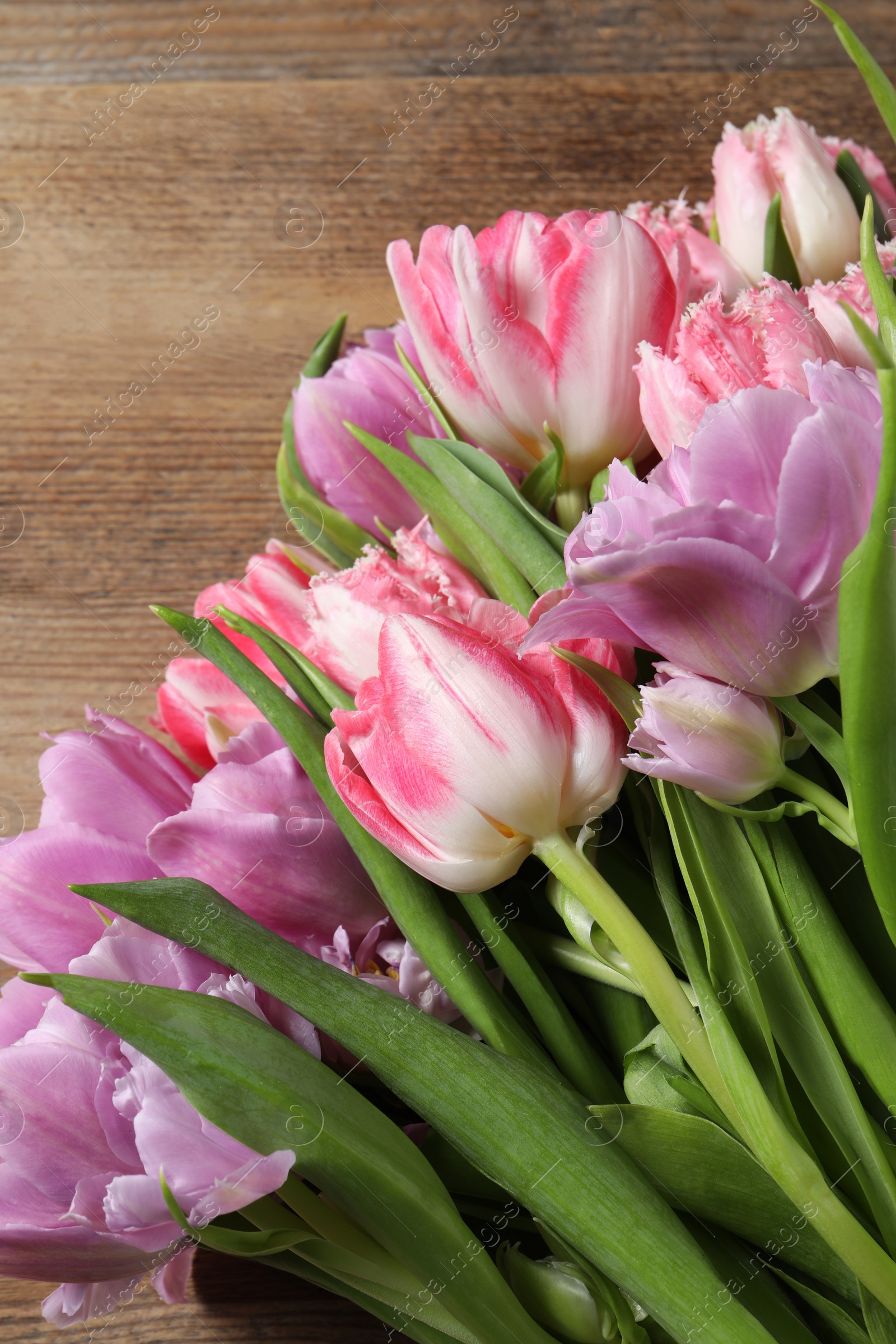 Photo of Beautiful bouquet of colorful tulip flowers on table, top view