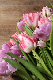 Beautiful bouquet of colorful tulip flowers on table, top view