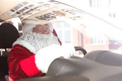 Authentic Santa Claus in car, view through windshield