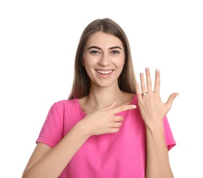 Photo of Happy young woman wearing beautiful engagement ring on white background