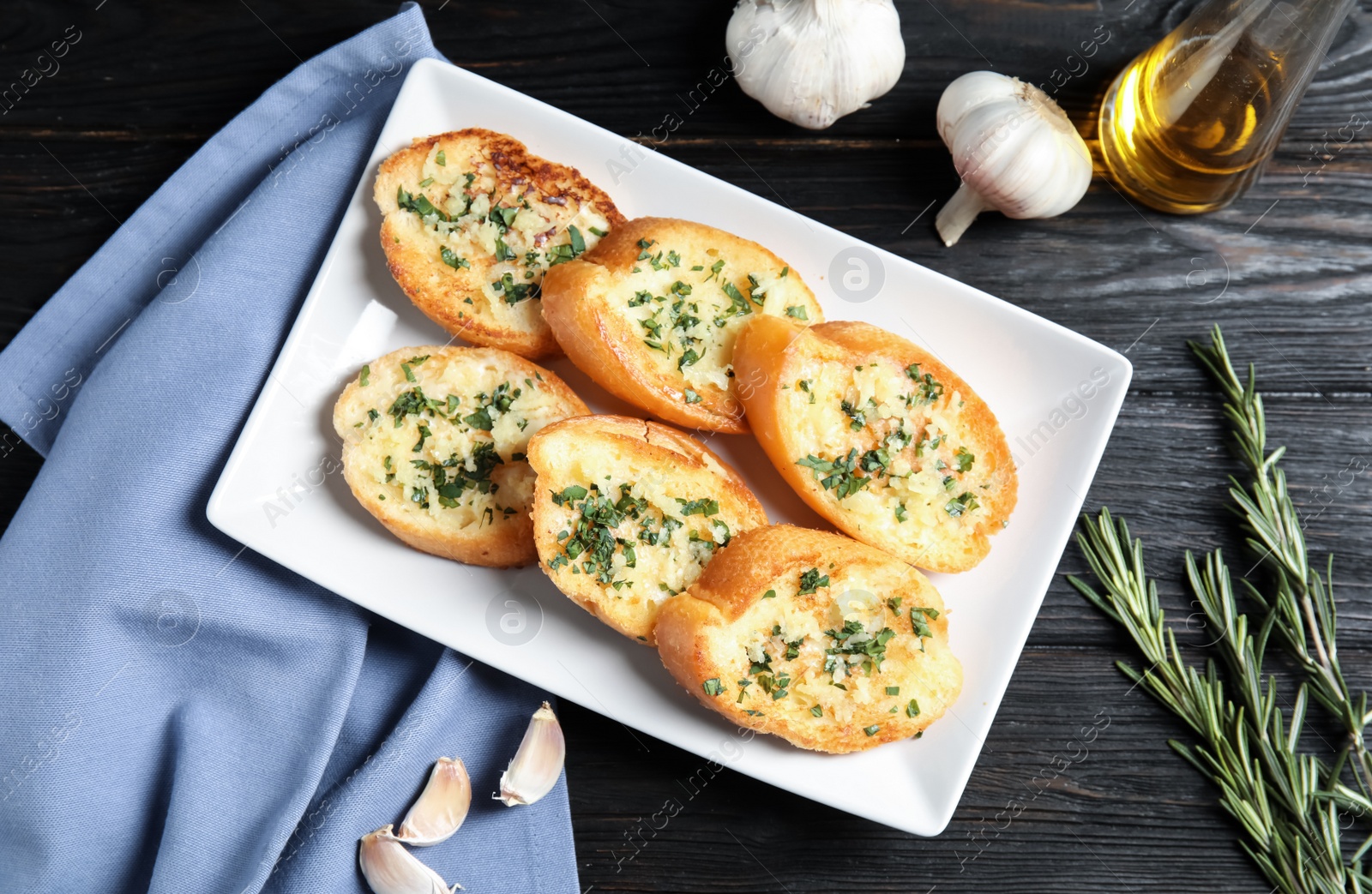 Photo of Flat lay composition with tasty garlic bread on table