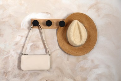Photo of Stylish bag and hat on rack indoors