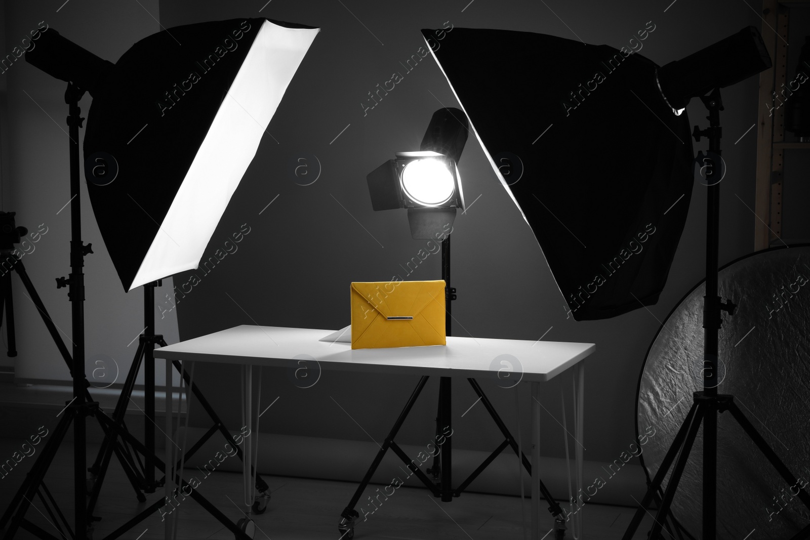 Photo of Professional photography equipment prepared for shooting stylish bag in studio