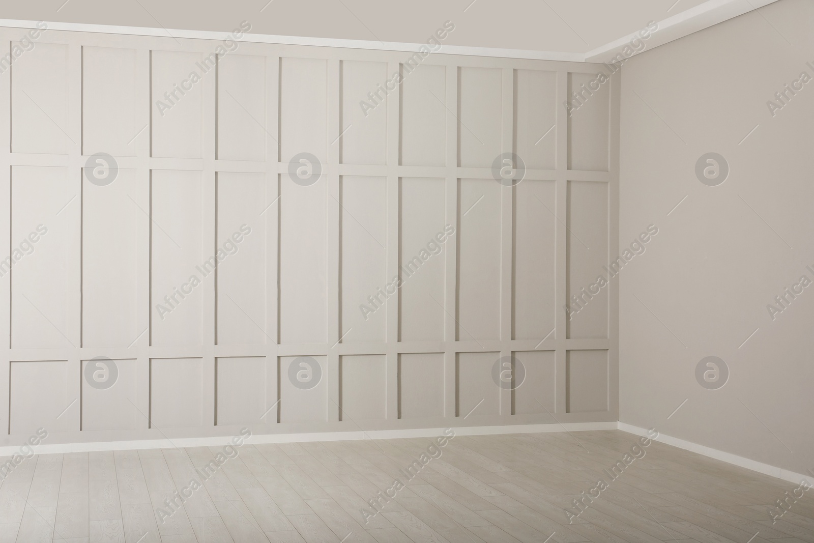 Photo of Empty room with beige walls and laminated flooring