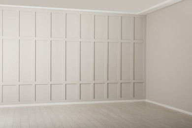 Photo of Empty room with beige walls and laminated flooring