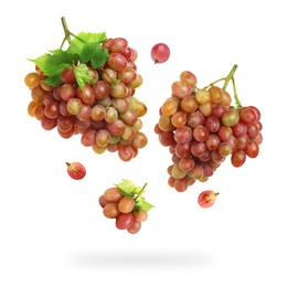 Fresh grapes and leaves in air on white background