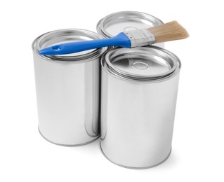 Photo of Cans of paints and brush on white background