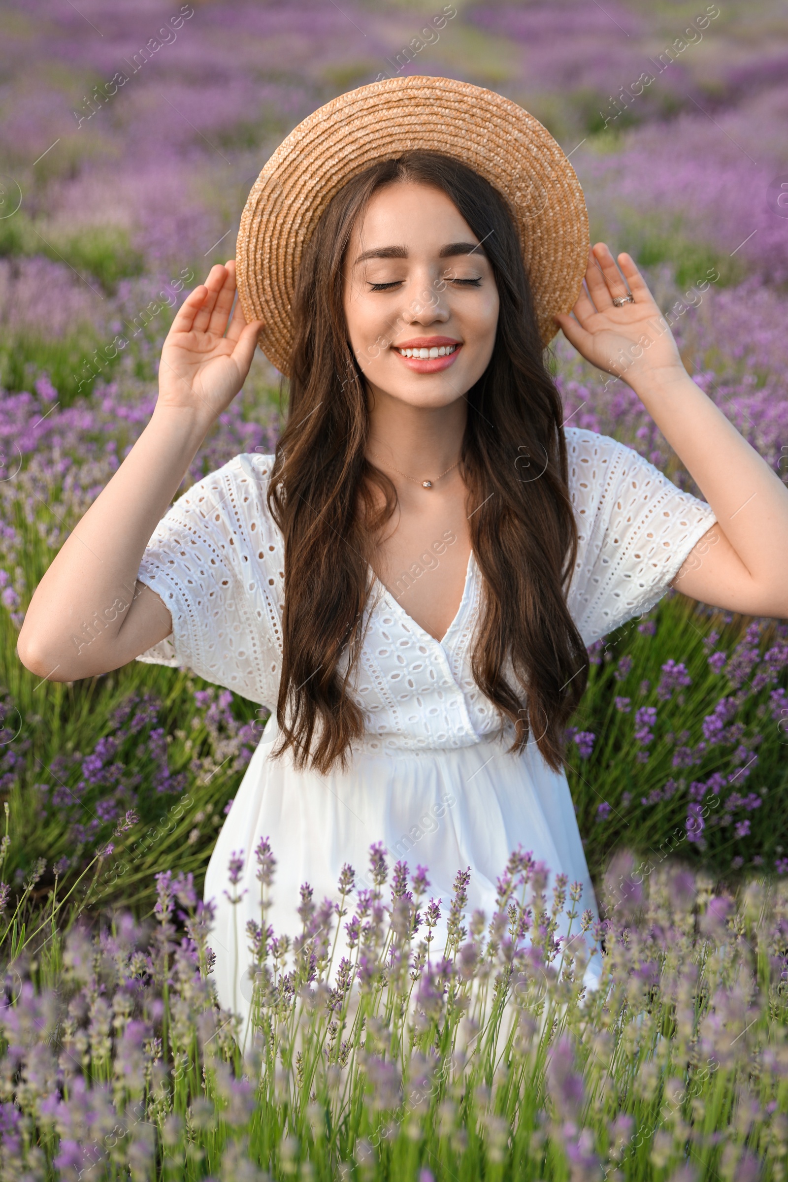 Photo of Young woman in lavender field on summer day