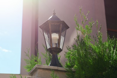 Pillar with vintage street lamp outdoors on sunny day