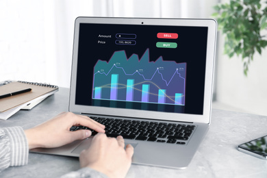  Broker working with laptop at table, closeup. Forex trading