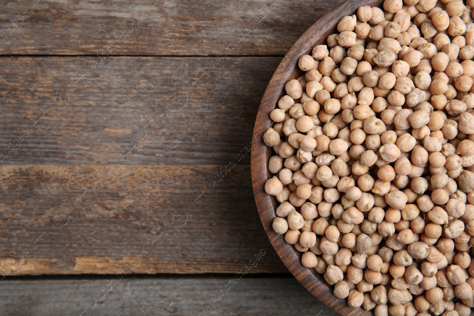 Photo of Plate with dried peas on wooden background, top view