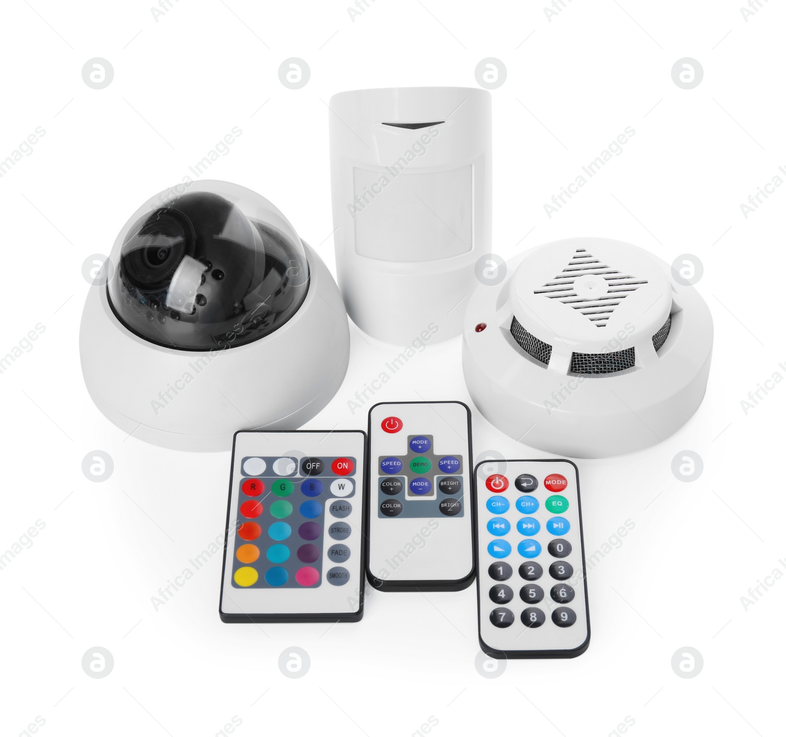 Photo of CCTV camera, remote controls, smoke and movement detectors on white background. Home security system