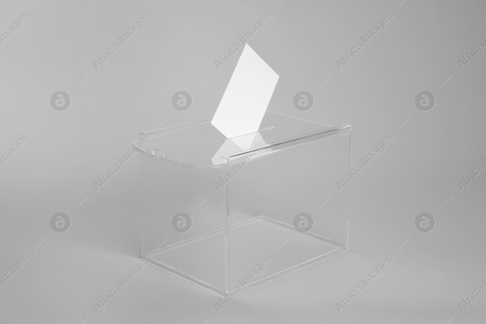 Photo of Ballot box with vote on light grey background. Election time