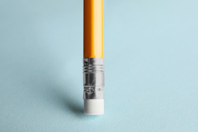 One graphite pencil on light blue background, closeup