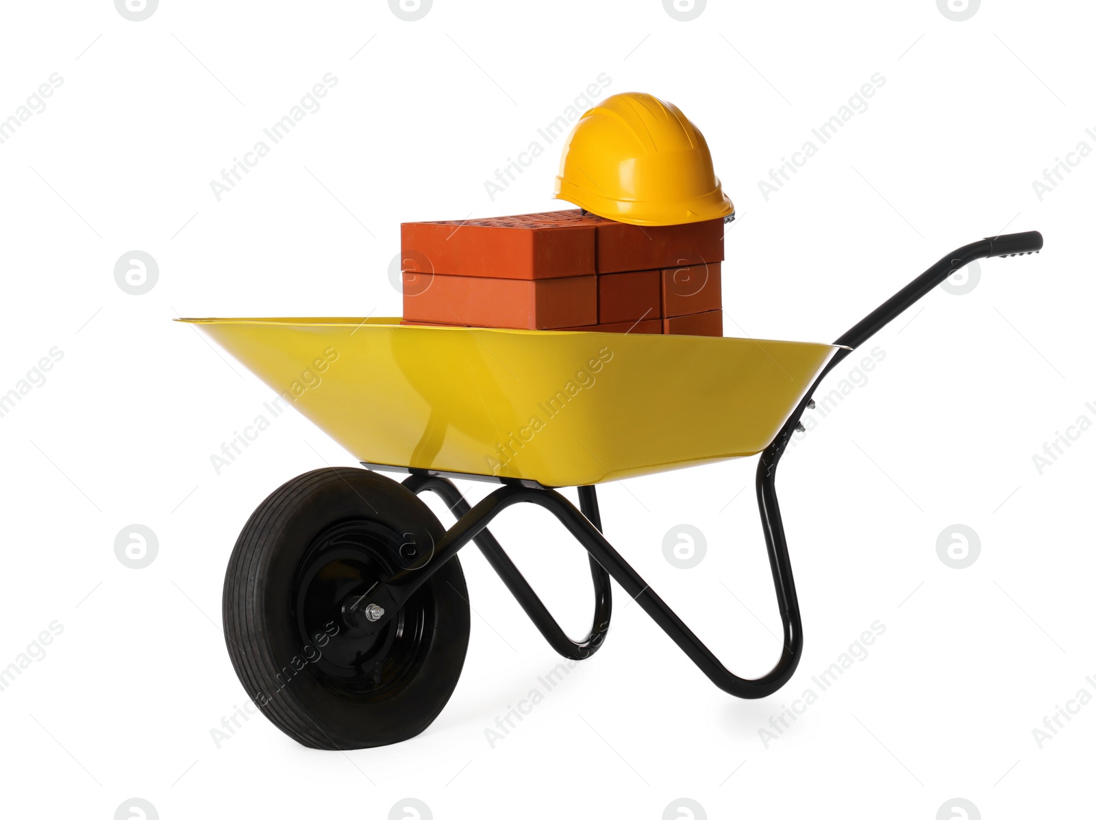 Photo of Red bricks and hard hat in wheelbarrow on white background
