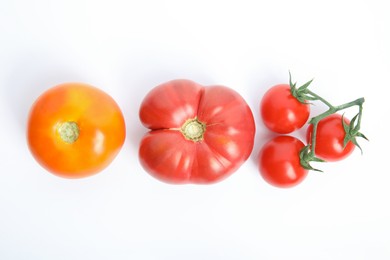 Photo of Many different ripe tomatoes on white background, flat lay