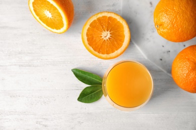 Photo of Composition with fresh orange juice on wooden background, flat lay. Space for text