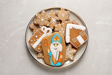 Photo of Tasty gingerbread cookies on light table, top view. St. Nicholas Day celebration