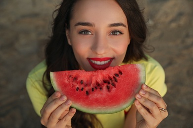 Photo of Beautiful young woman with watermelon outdoors, top view