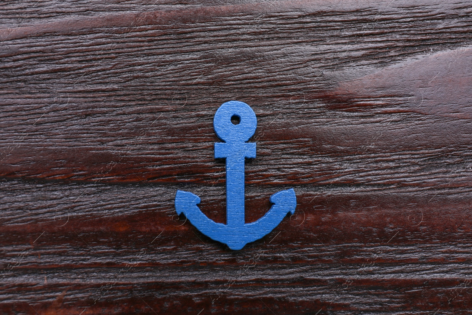 Photo of Anchor figure on dark wooden table, top view