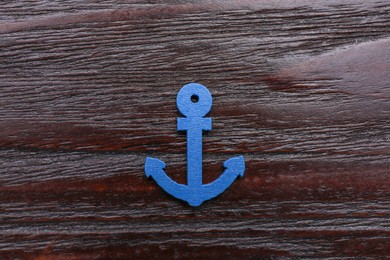 Photo of Anchor figure on dark wooden table, top view