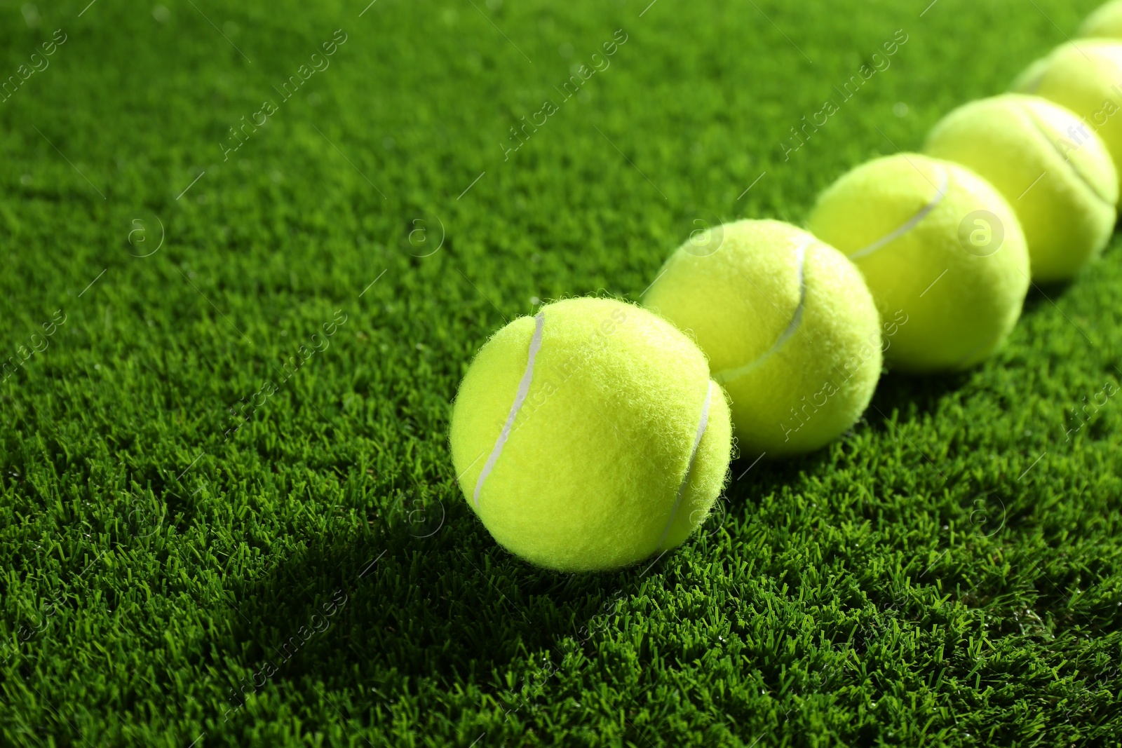 Photo of Tennis balls on green grass. Sports equipment