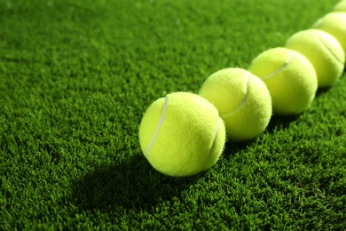 Tennis balls on green grass. Sports equipment