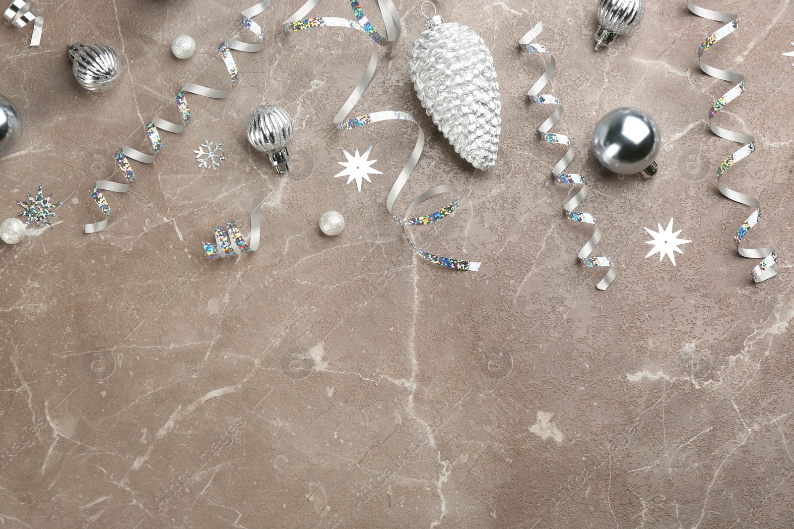 Photo of Flat lay composition with serpentine streamers and Christmas decor on grey background. Space for text